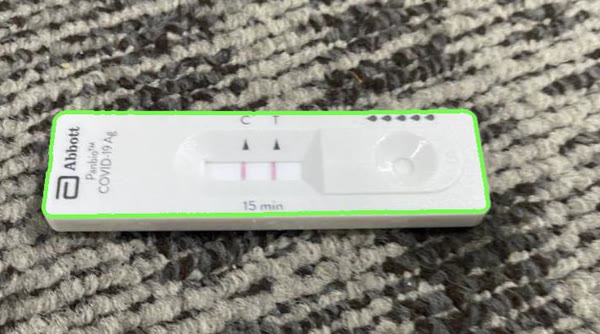 COVID-19 rapid test outlined in green by color-based detection